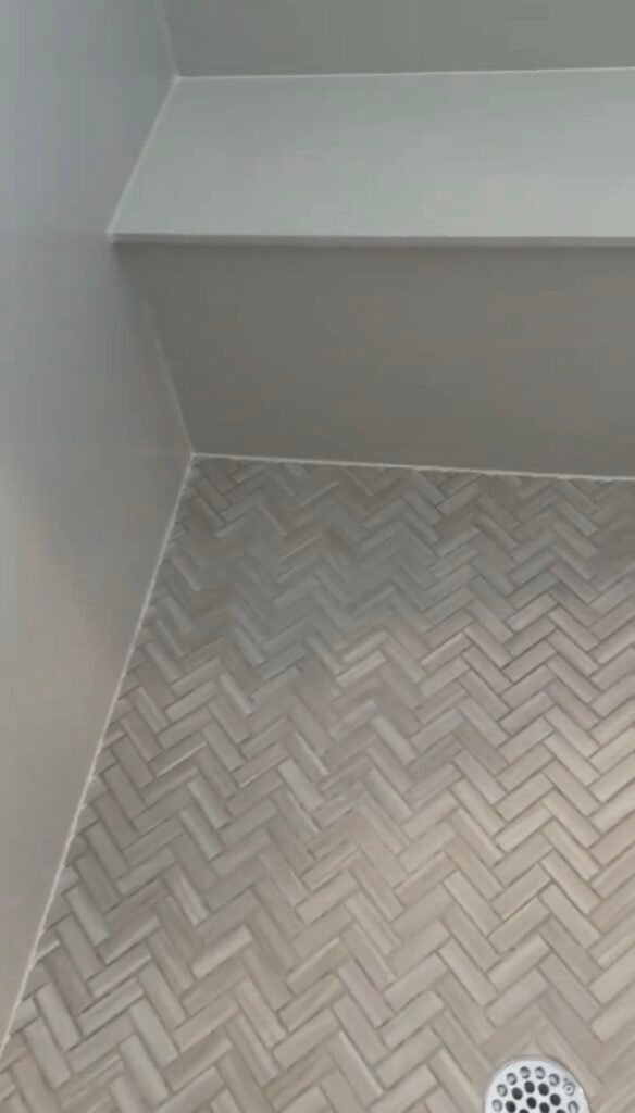new white silicone at shower floor joint