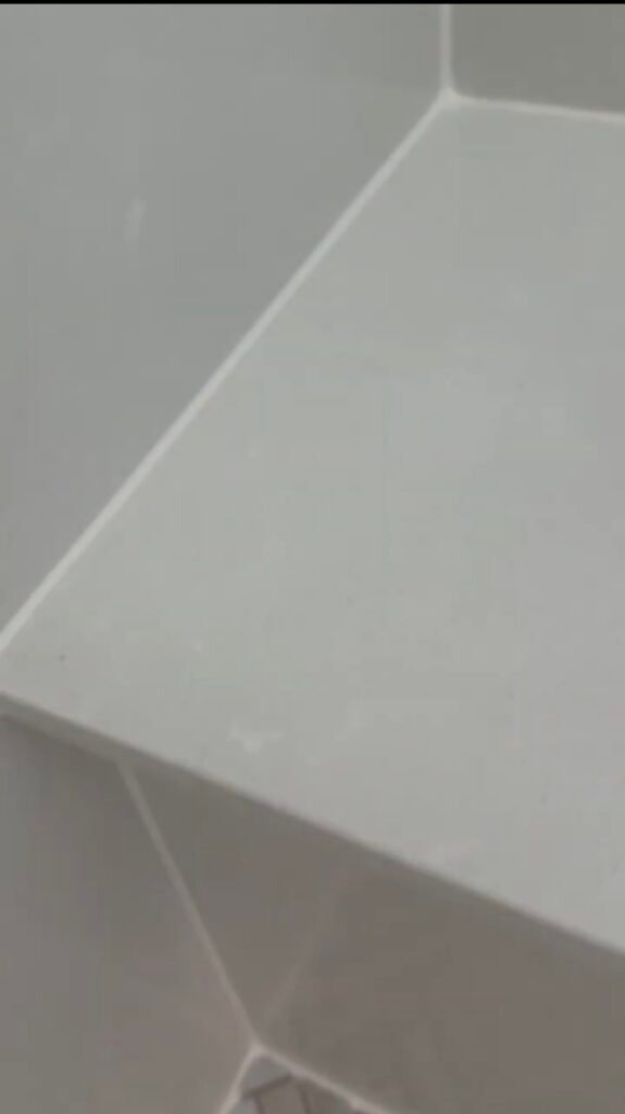 Piedrafina shower panel corner silicone line