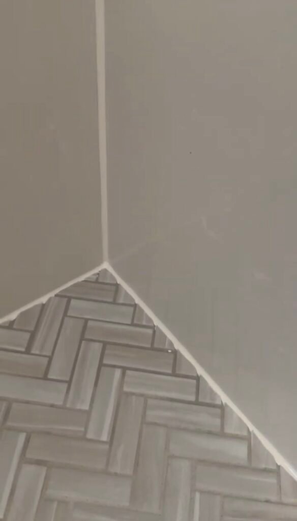 shower floor corner seam with new silicone sealant