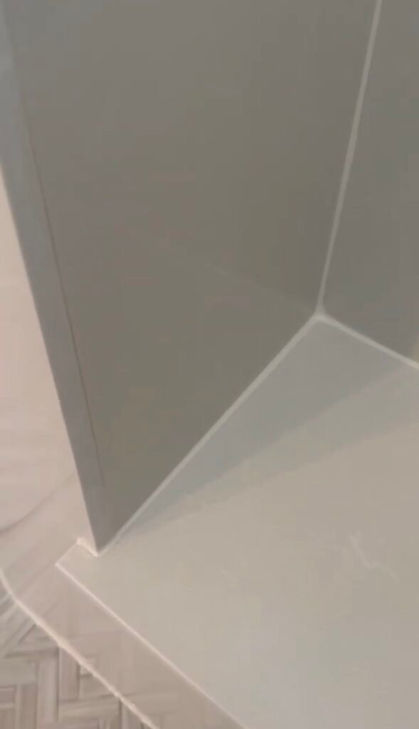 new white silicone at the built-in seat of the shower
