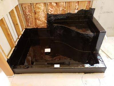 Waterproofing liner installed over sloped mortar bed