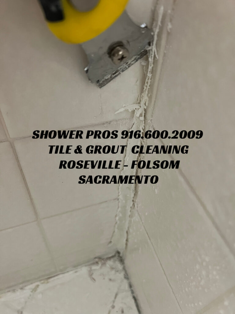 removing shower caulk with razor tool