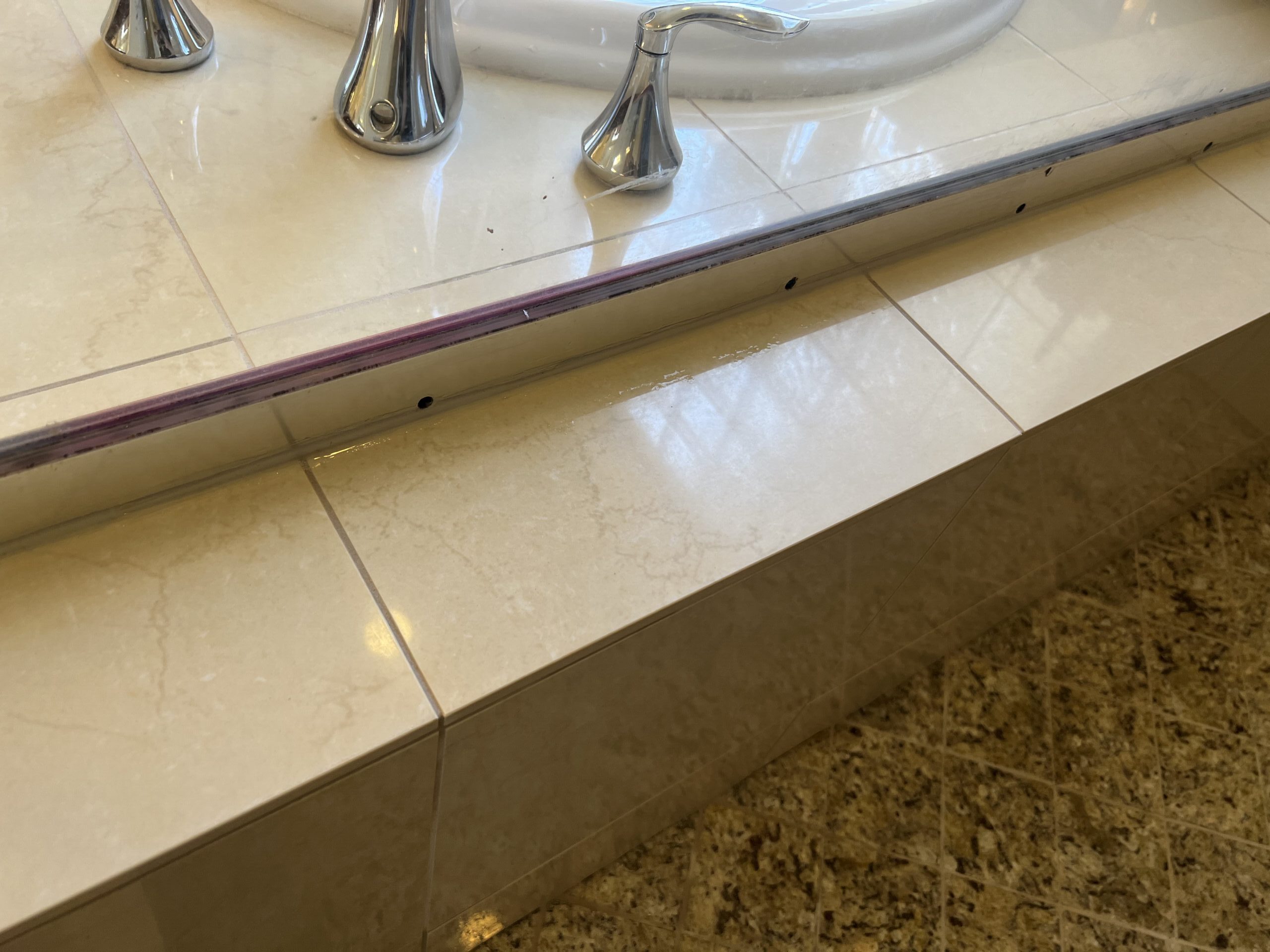 Freshly applied grout packed flush into marble panel seams