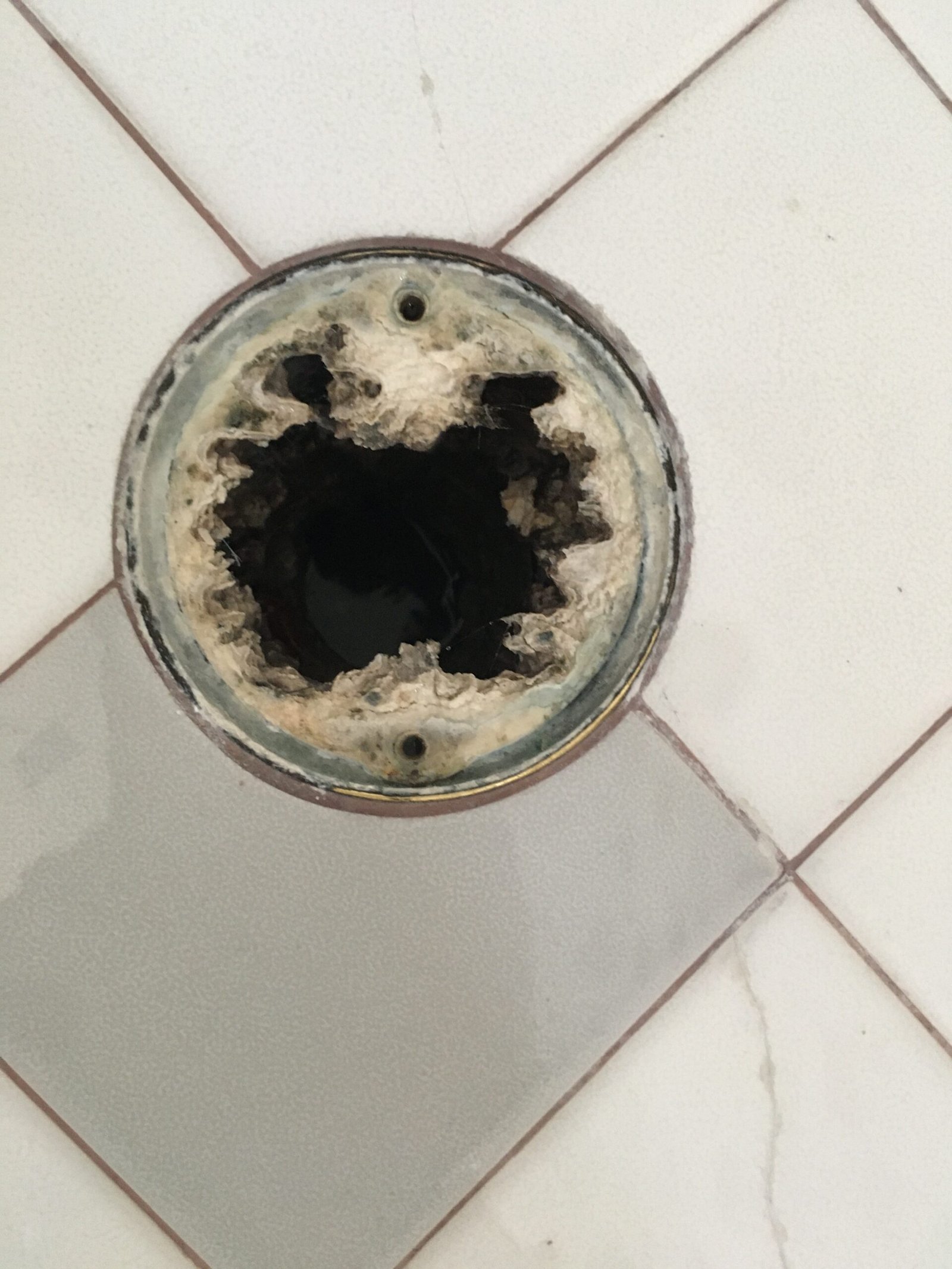 Clearing plumbing debris and opening sub surface weep holes during a shower drain line inspection