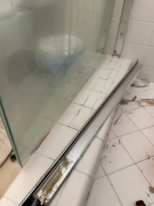Stagnant moisture and failed seals along the glass track perimeter