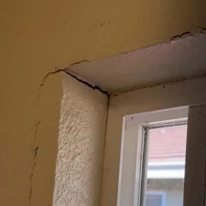 Drywall cracks around the shower window framing