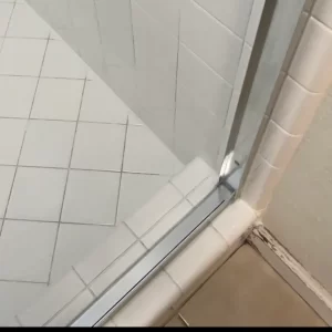 Glass aluminum frame cleaned to a brilliant shine and sealed with clear 100% silicone
